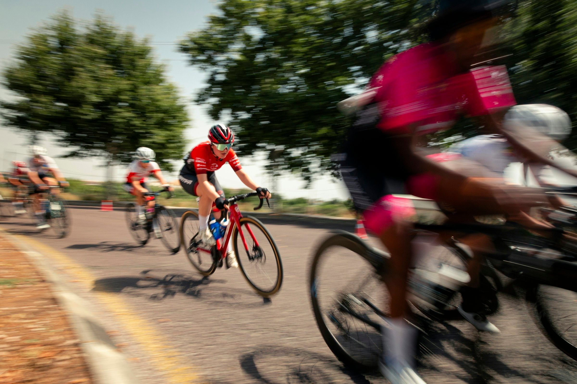 Cyclists racing round a bend with motion blur